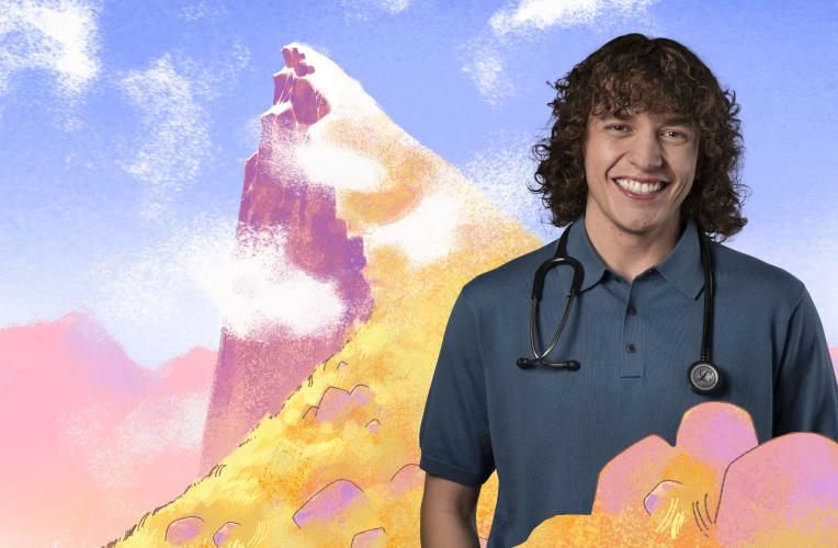 Medical student angus stands in front of a mountain